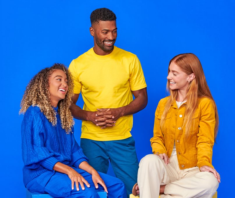 This image shows three friends talking and laughing